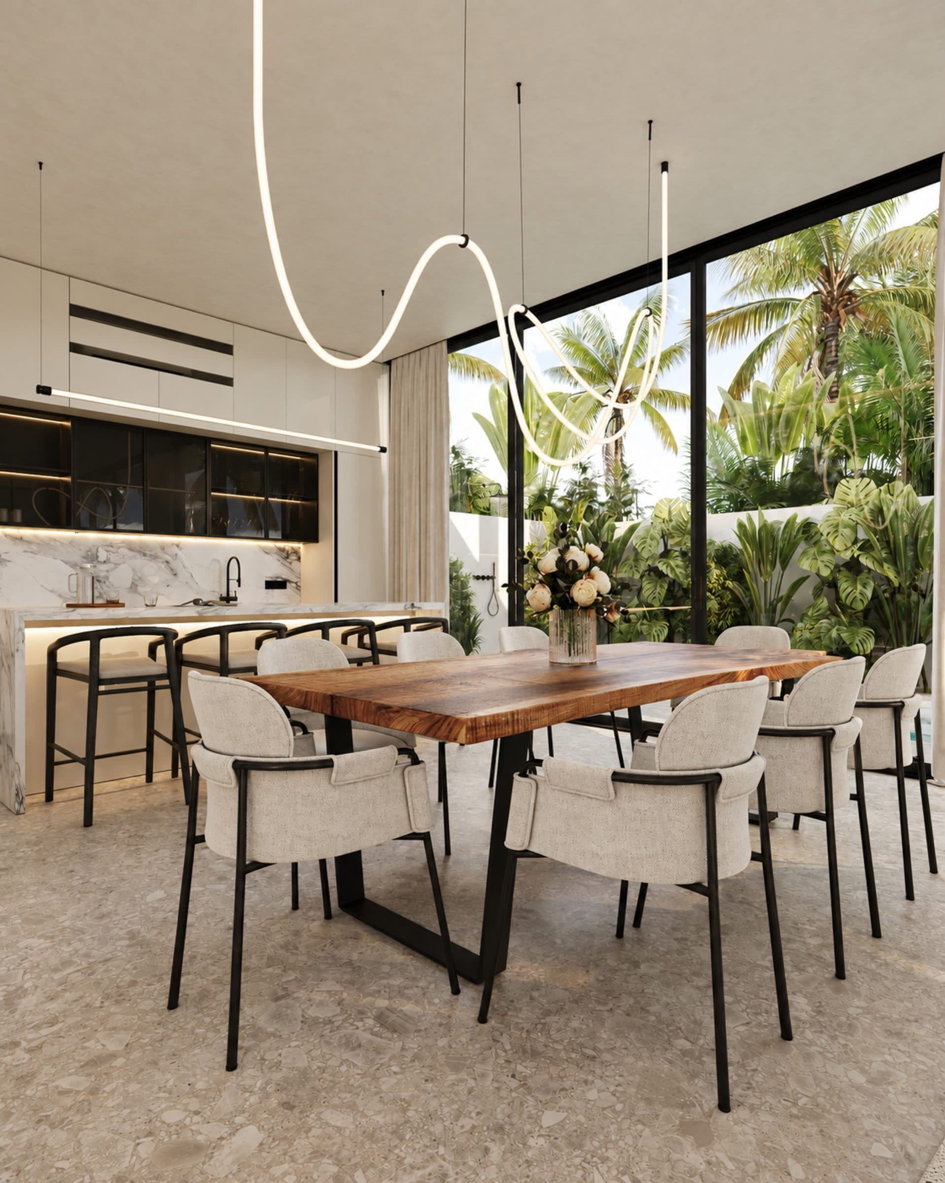 Haven Villa dining space with a timber table, marble kitchen island and a view to the garden